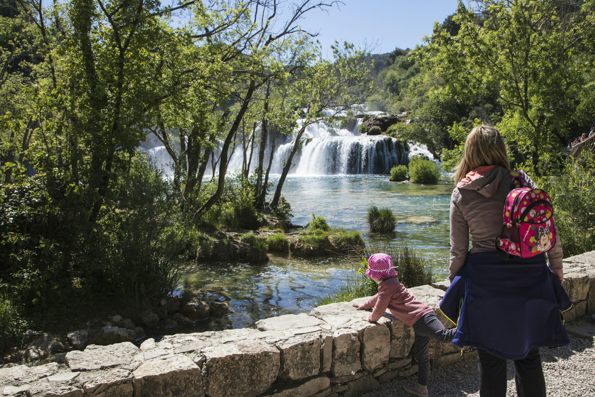 Mother and child overlook waterfalls at Krka National Park, near Skradin, Sibenik-Knin. 