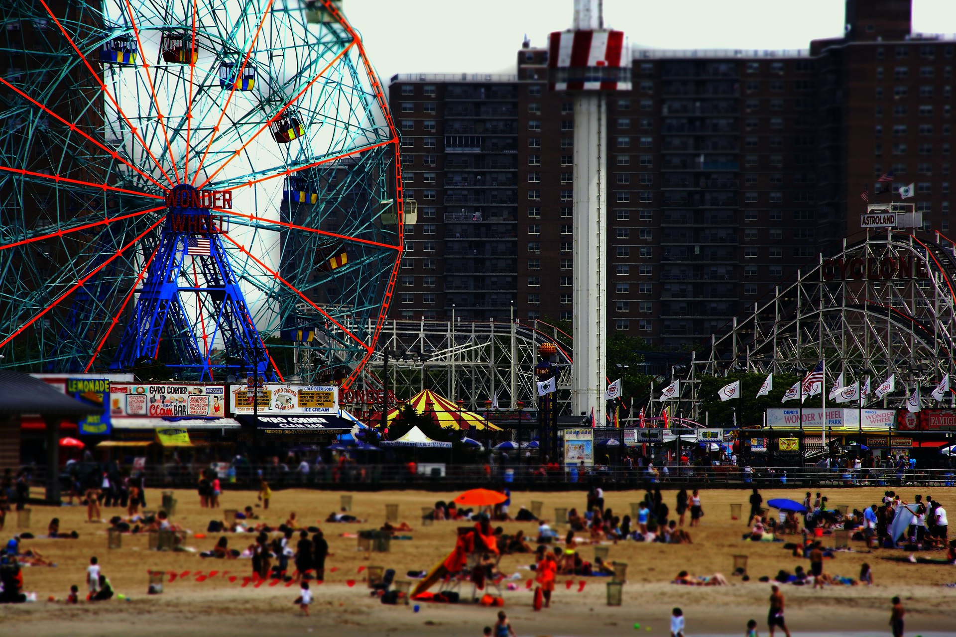 Amusement rides and beachgoers on Coney Island, Brooklyn, New York City, New York, USA
