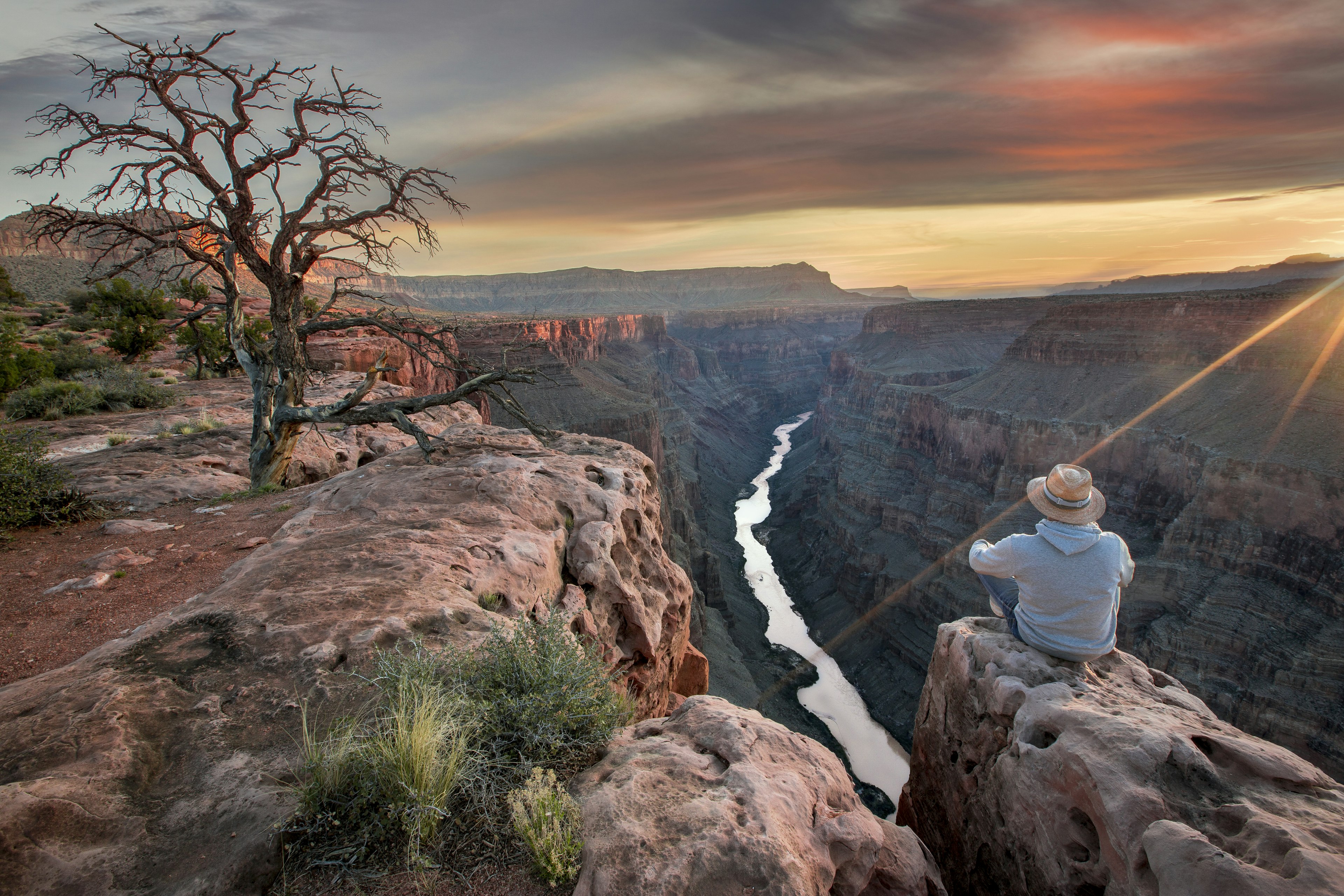 Man viewing Grand Canyon at sunrise