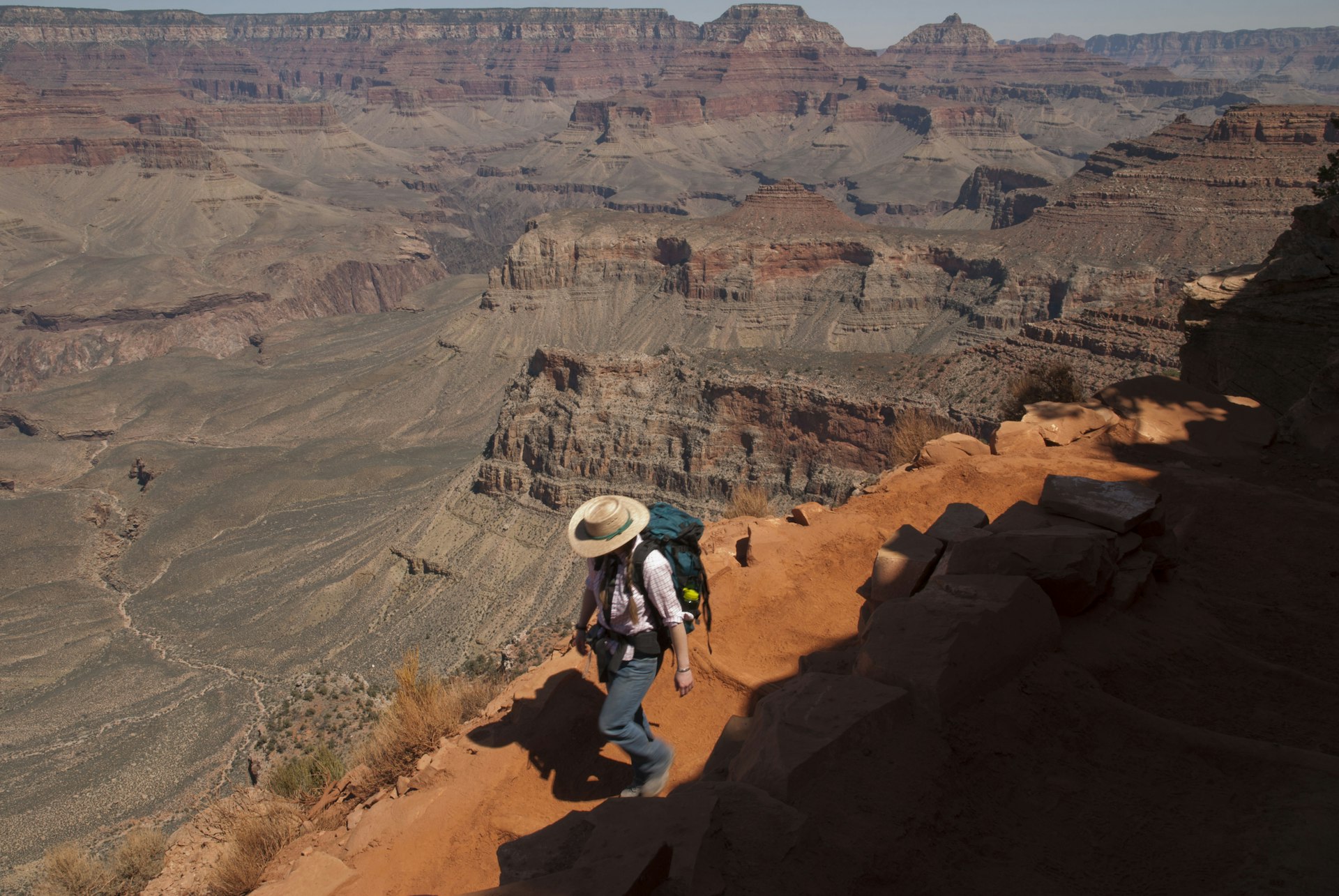 Woman hiking the Grand Canyons Kaibab Trail on the South Rim of the Grand Canyon National Park. rizona, Nature, Mountain, Adults Only, Women, Mid Adult, Cliff, Physical Geography, Arid Climate, One Mid Adult Woman Only, South Rim, Grand Canyon National Park, Hat, Arizona, Extreme Terrain, Tranquility, Landscape, Outdoors, High Angle View, Color Image, Desert, People, Landscape - Scenery, USA, Hiking, Southwest USA, Tasm