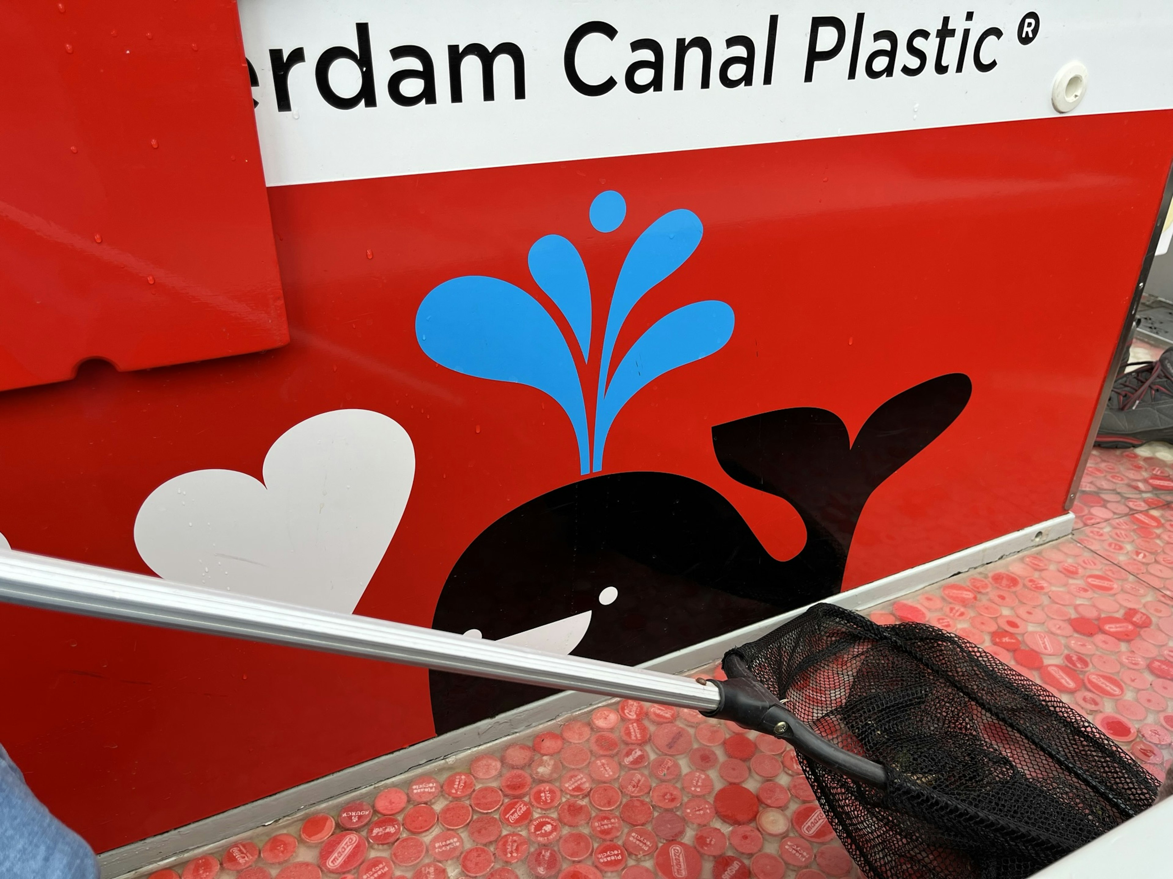 The floor of the boat, which is sponsored by the city of Amsterdam, is collaged with red and white bottle caps in the design of the city's flag