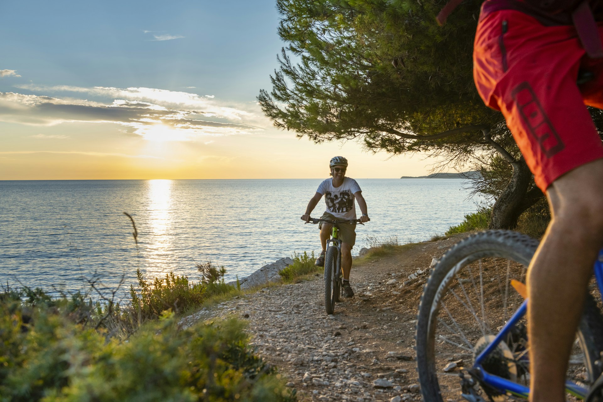 Cyclists on trails at sunset at Cape Kamenjak, Croatia