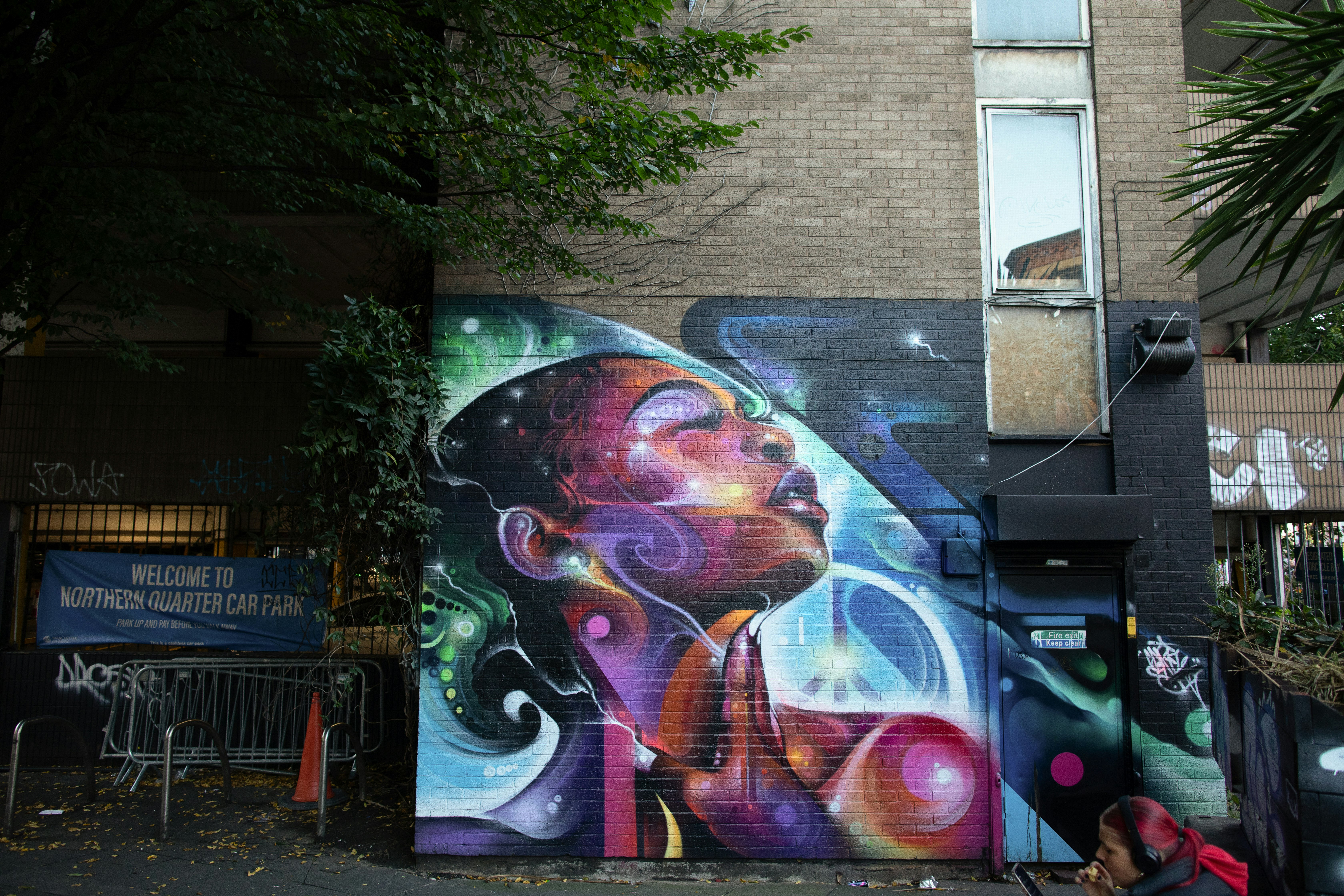 A display of street art in Manchester shows a woman looking to the sky. 