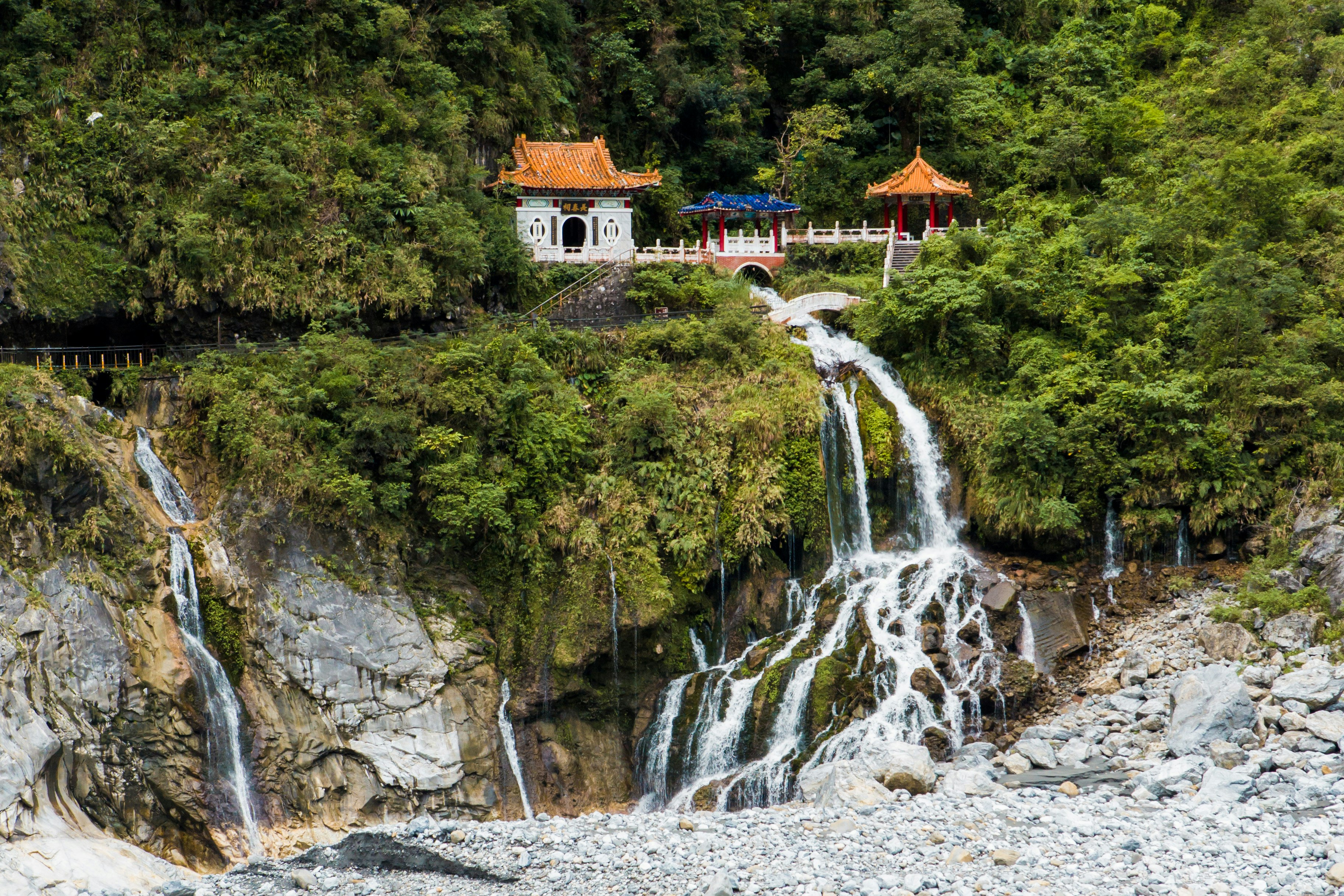 A temple in the mountains overlooking a gorge, built over rushing water