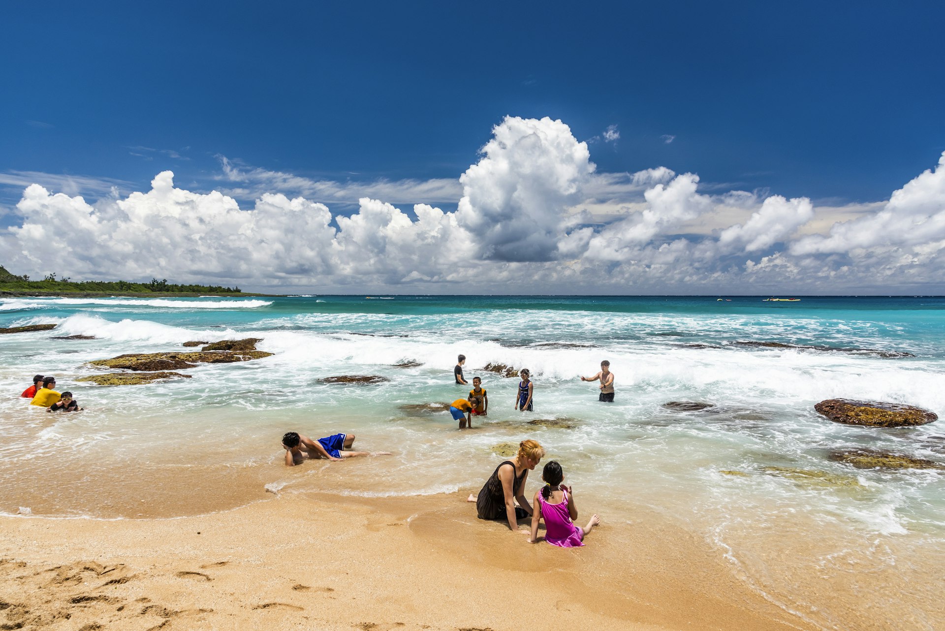 Tourists playing on the beautiful Baishawan coastal reef and sea waves in Kenting National Park of Pingtung, Taiwan