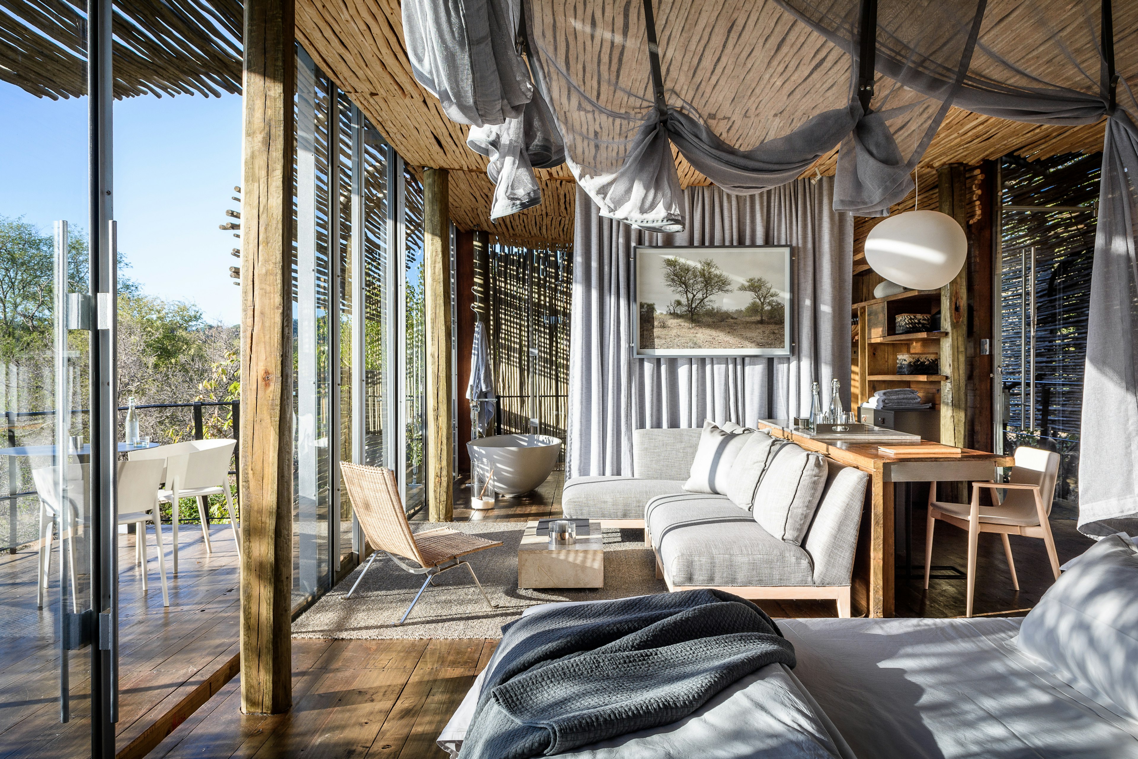 Interior shot of a modern, light-filled safari lodge bedroom and bathroom