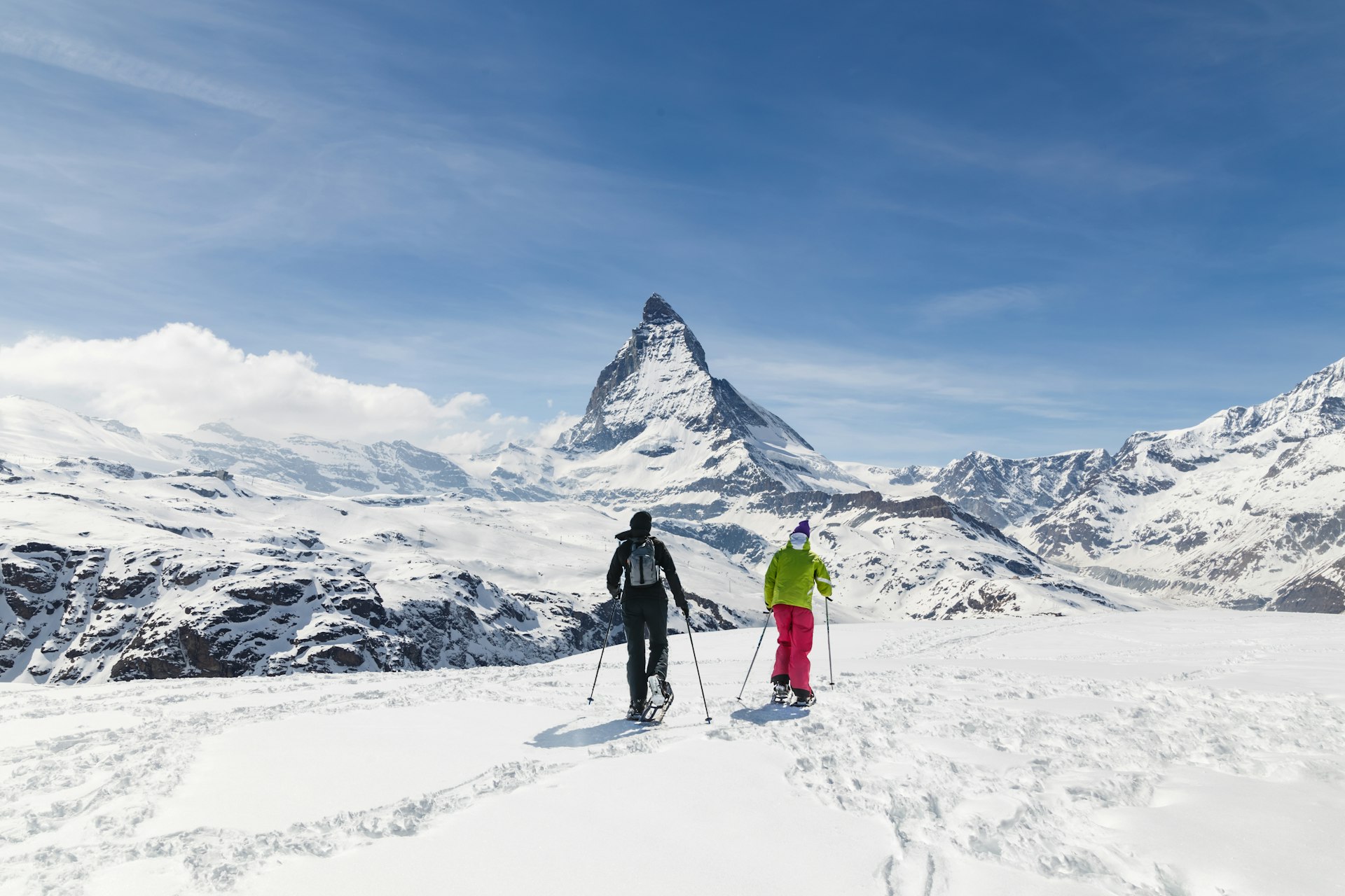 Two skiiers in front of the the Matterhorn, Zermatt, Switzerland, Europe