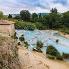 People bathing at a natural spa with waterfalls in Saturnia.
688273828
bath, bathing, cascade, countryside, etruscan, fall, geothermal, hot water, hydrothermal, idyllic, italy, landscape, natural, natural pool, picturesque, river, rural, saturnia, skincare, spa, sulphur, thermal, tuscany, waterfall, wellness