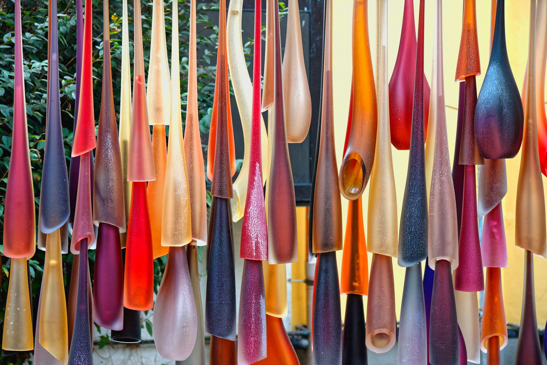 Scores of colourful, hand-blown glasses are suspended like stalactites at a glass manufacturing factory on Murano island, Venice