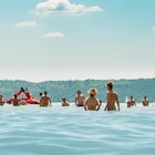 Balatonfured / Hungary - July 20th, 2019: people are having fun, chilling, and swimming in the lake Balaton on a very hot summer day.; Shutterstock ID 1506798605; your: Claire Naylor; gl: 60505; netsuite: Online editorial; full: Budapest day trips
1506798605