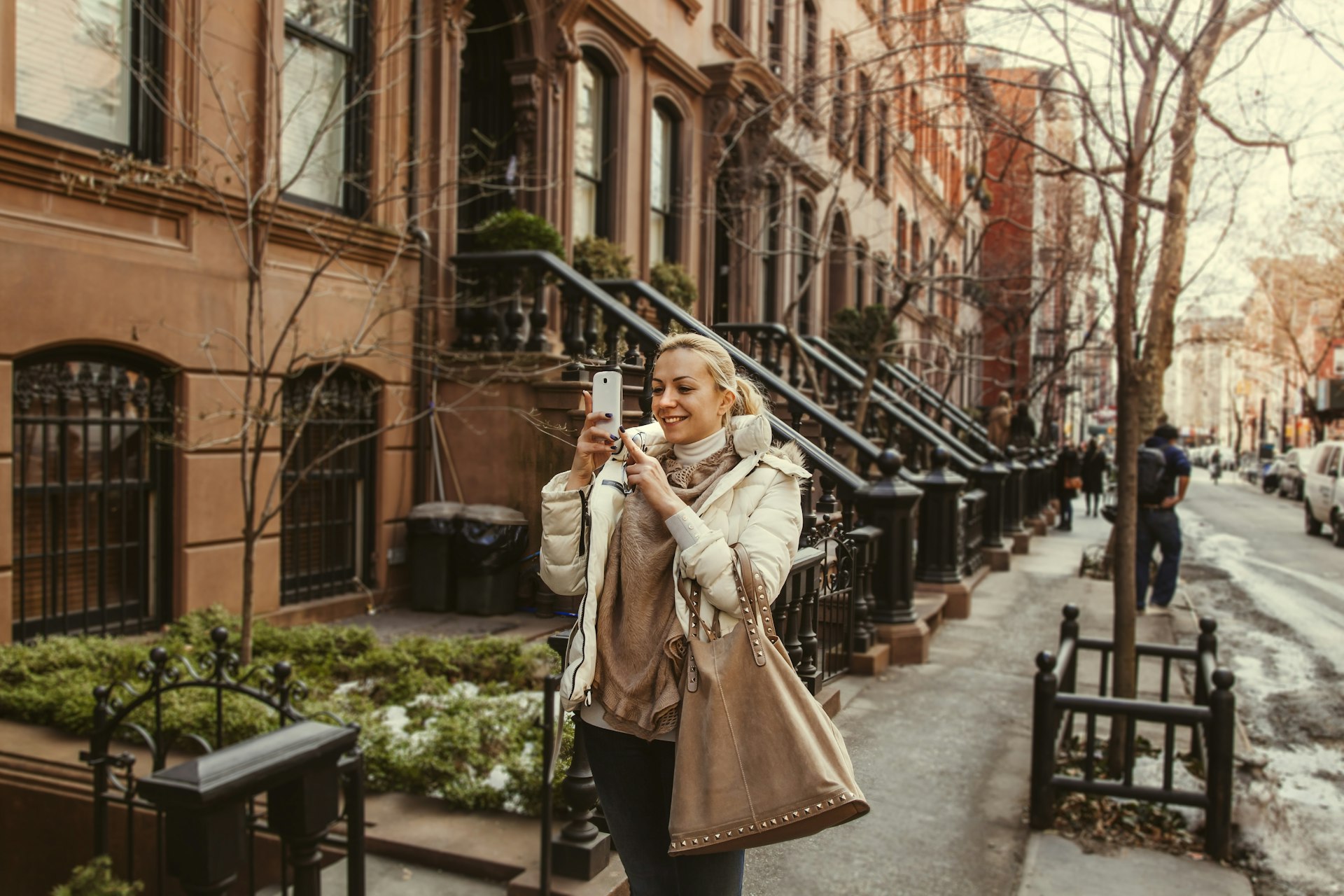 A woman takes a selfie on Perry St in the West Village, Greenwich Village, Manhattan, New York City, New York, USA