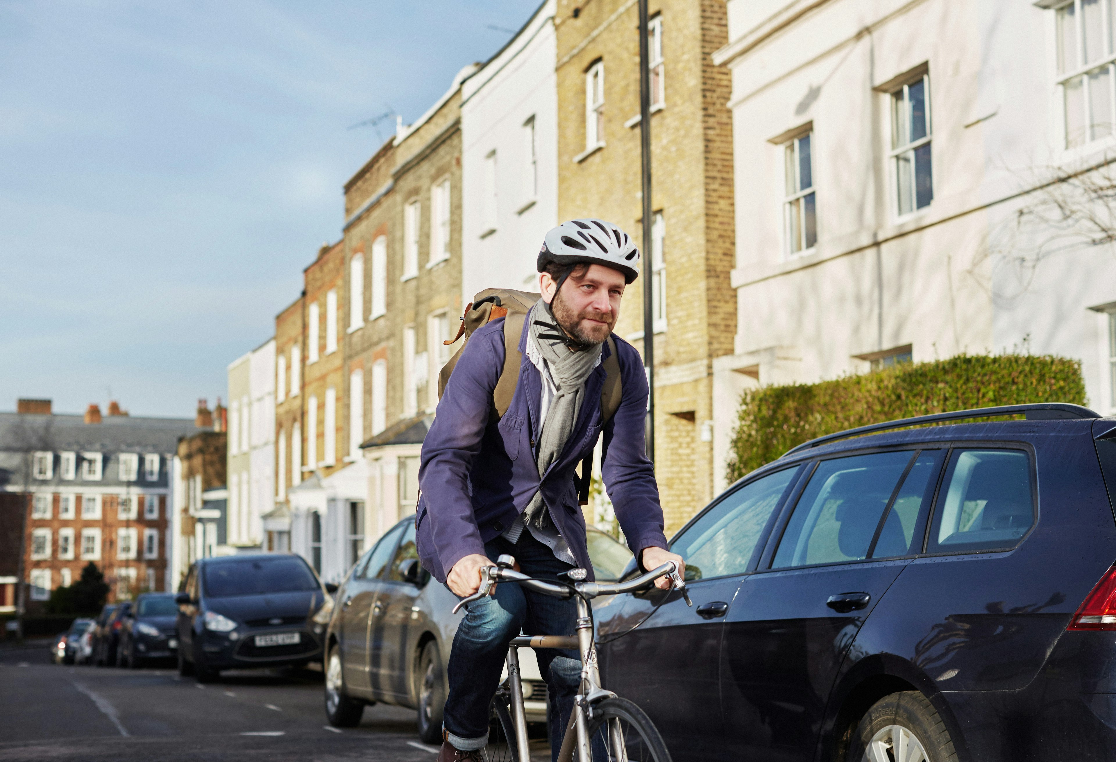 A man rides a bicycle in a quiet street in London, England, United Kingdom