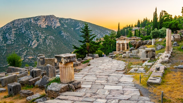 Sunset view of Athenian treasury at the ancient delphi site in Greece