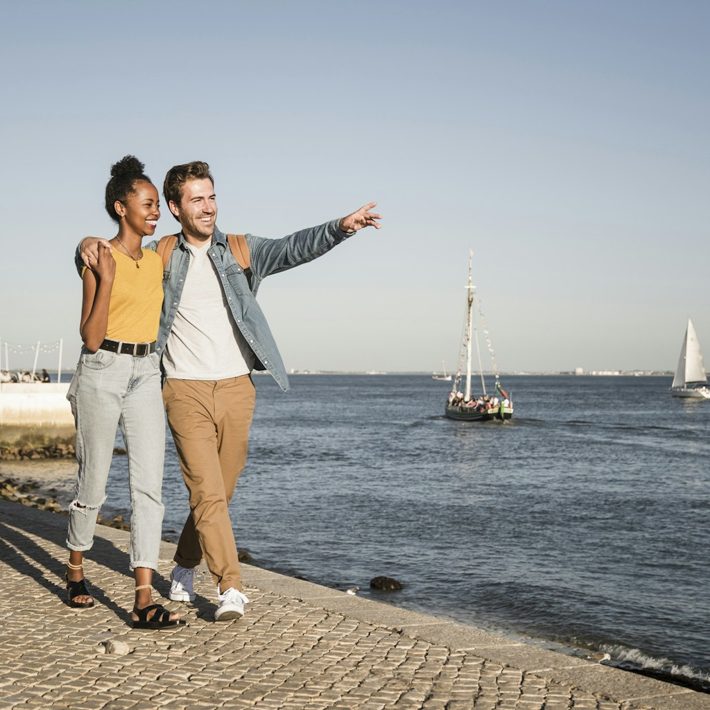 1199658925
adult couple, blue sky, content, emotion, emotional, female tourist, landscape, mixed race couple, riverside, traveller, vessel, waterfront promenade
Happy young couple walking on pier at the waterfront, Lisbon, Portugal