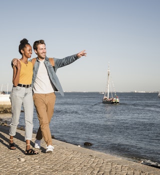1199658925
adult couple, blue sky, content, emotion, emotional, female tourist, landscape, mixed race couple, riverside, traveller, vessel, waterfront promenade
Happy young couple walking on pier at the waterfront, Lisbon, Portugal