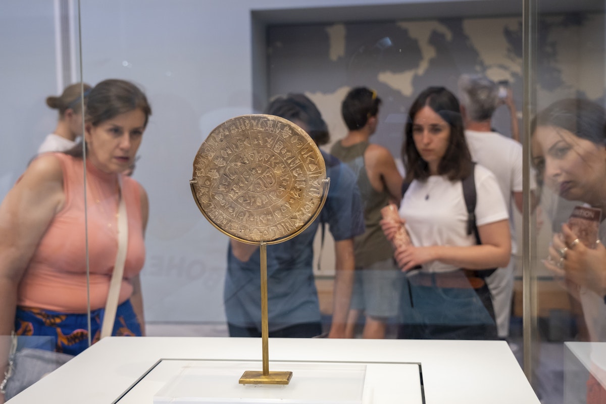 Tourists looking at the Phaistos Disc inside the archaeological museum of Heraklion in Crete that hold the most important and complete collection of the Minoan civilisation of Crete on the 28th of August 2022 in Crete, Greece. Many of the artefacts  in the museum come from Knossos, the largest Bronze Age archaeological site on the Greek island of Crete. (photo by Andrew Aitchison / In pictures via Getty Images)
1245671474
aitchison, greek, heraklion, neolithic, phaistos disc, archaeological, artefacts, ceremonial, civilization, culture, explore, holiday, remains, statues, tourists, viewing