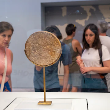 Tourists looking at the Phaistos Disc inside the archaeological museum of Heraklion in Crete that hold the most important and complete collection of the Minoan civilisation of Crete on the 28th of August 2022 in Crete, Greece. Many of the artefacts in the museum come from Knossos, the largest Bronze Age archaeological site on the Greek island of Crete. (photo by Andrew Aitchison / In pictures via Getty Images)
1245671474
aitchison, greek, heraklion, neolithic, phaistos disc, archaeological, artefacts, ceremonial, civilization, culture, explore, holiday, remains, statues, tourists, viewing