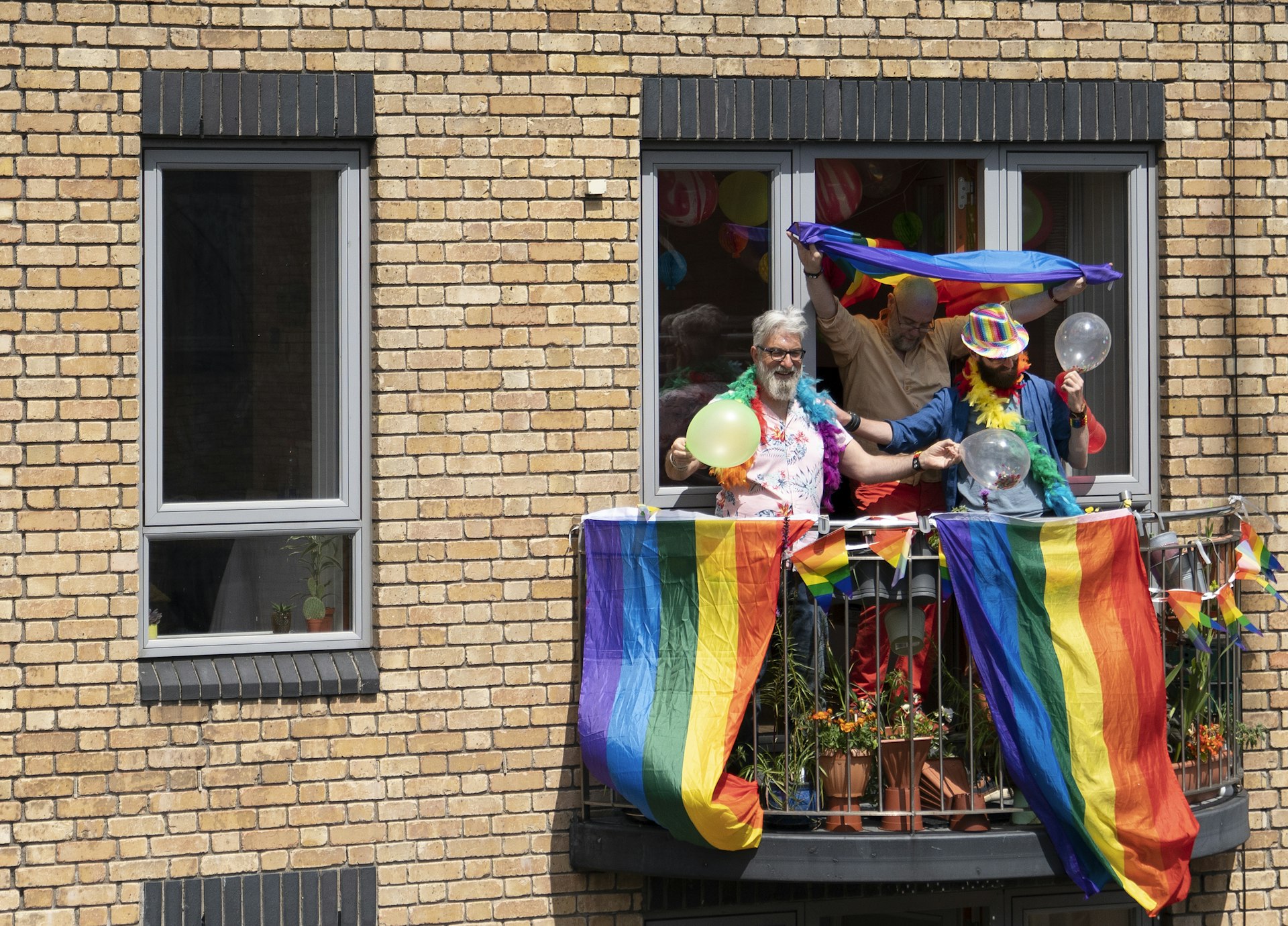 A group of friends celebrating Pride on their balcony, Dublin, Ireland