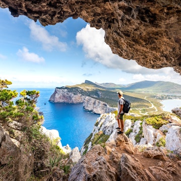 Hiker admiring the view from Capo Caccia.