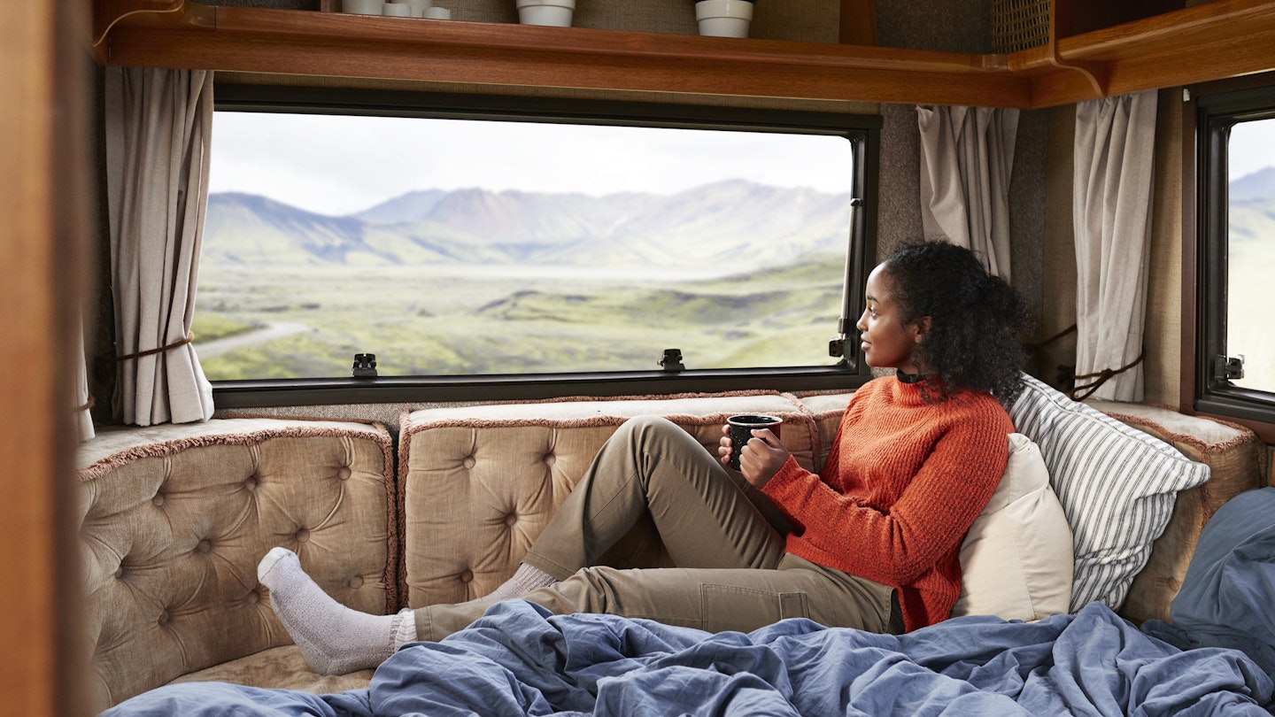 Contemplating woman with coffee cup sitting on bed in camper van
1291775664
Woman with a coffee cup on a bed in a camper van in Iceland