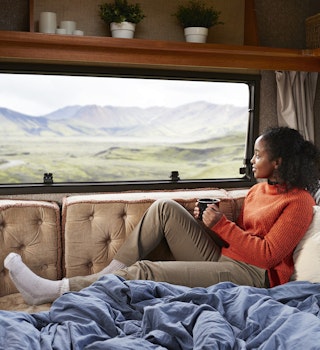 Contemplating woman with coffee cup sitting on bed in camper van
1291775664
Woman with a coffee cup on a bed in a camper van in Iceland