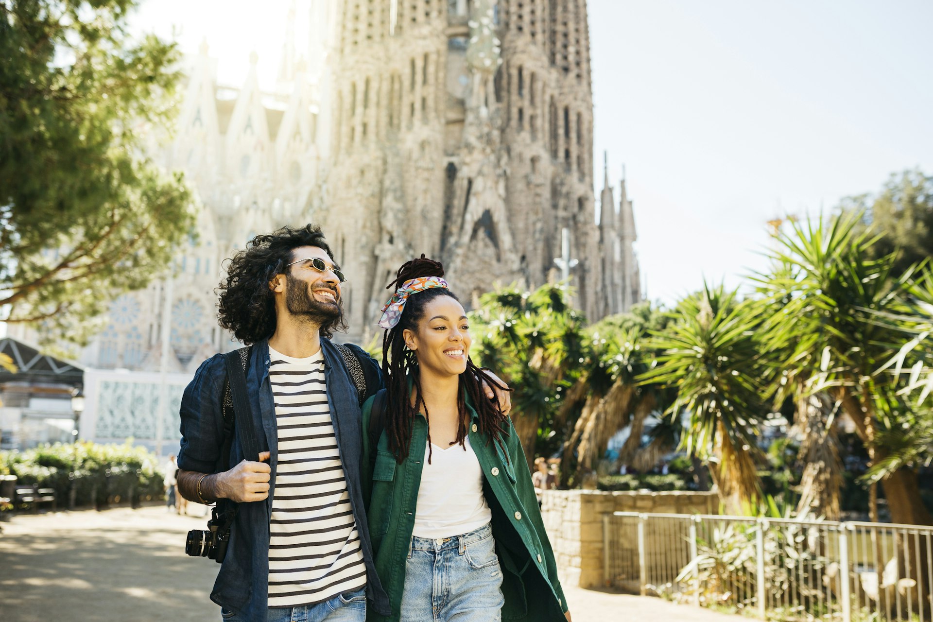 Smiling couple walking around Sagrada Familia church at Barcelon