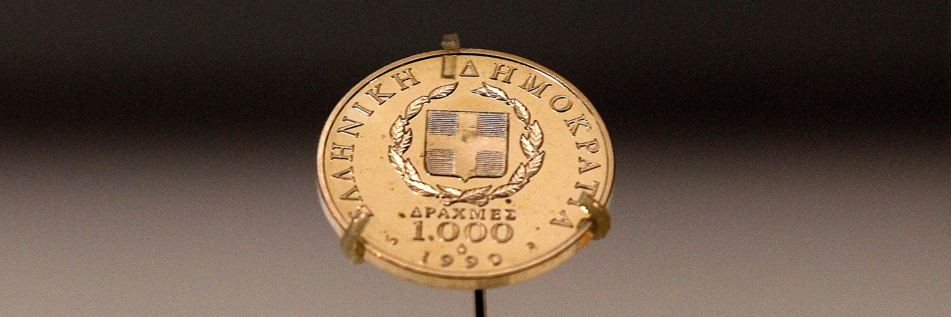 A Greek 1,000 drachma coin dating from 1999, sits on display in a secure cabinet at the Bank of Greece museum in Athens, Greece, on Tuesday, Feb. 14, 2012. European officials ratcheted up the pressure on the Greek government to deliver budget cuts in exchange for a second bailout as they insisted that default is not an option. Photographer: Simon Dawson/Bloomberg via Getty Images
138990488
AUSTERITY, BAILOUT, CURRECY; CURRENCIES, CUTS, ECONOMY, EMEA, EUROPE, FINANCE, FINANCIAL