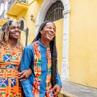 Cute, Fashionable Afro-Descendant Black Tourist Couple Walking Together on Date Night in the Street in Huerta Sandoval Neighborhood of Panama City, Panama
1426692018
A smiling couple walk arm in arm along the street in Panama City