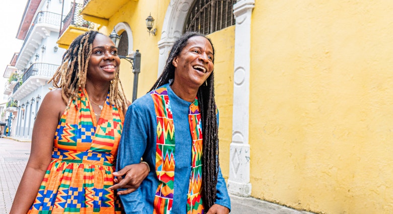 Cute, Fashionable Afro-Descendant Black Tourist Couple Walking Together on Date Night in the Street in Huerta Sandoval Neighborhood of Panama City, Panama
1426692018
A smiling couple walk arm in arm along the street in Panama City