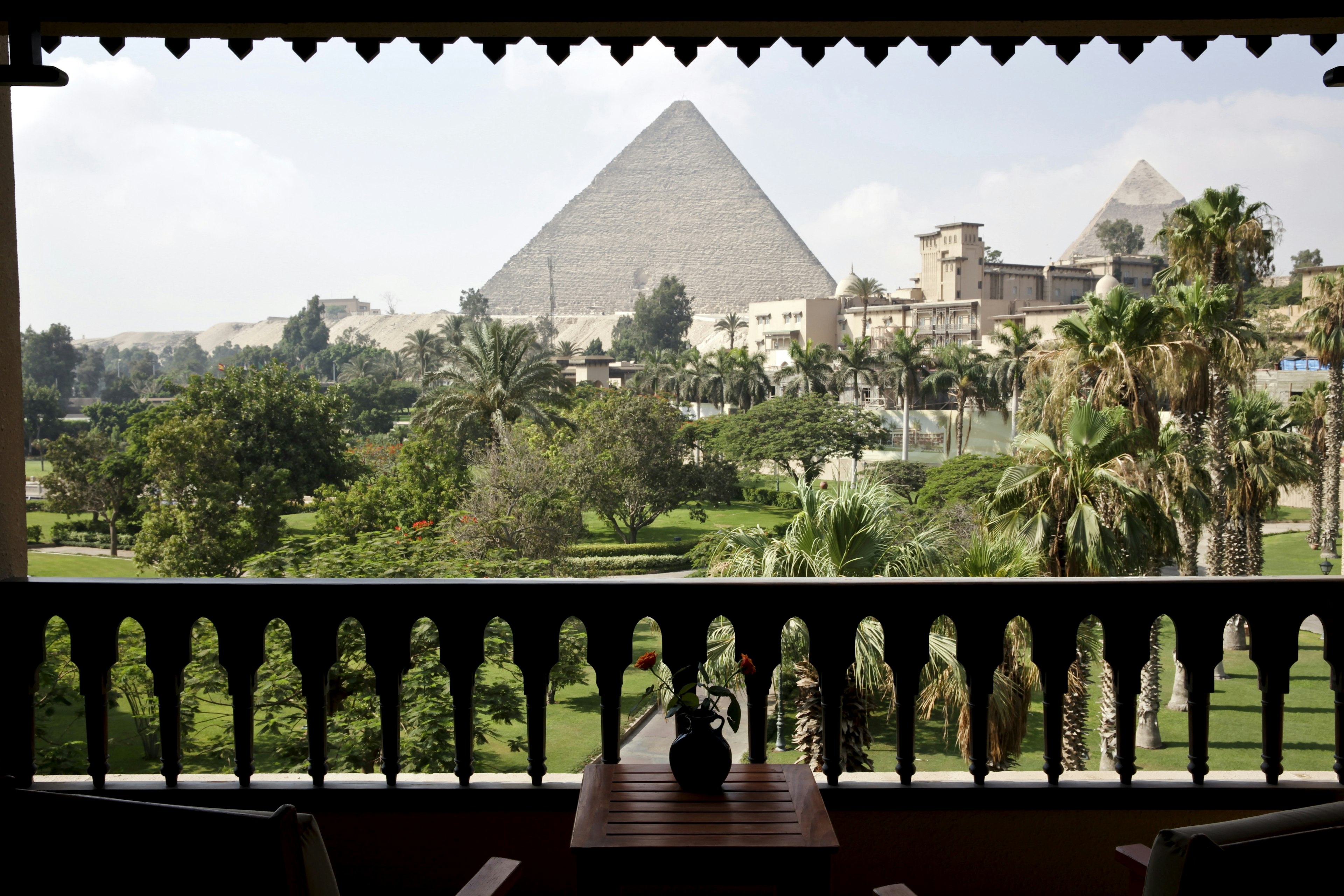 The ancient pyramids of Giza are seen from a hotel room beyond the gardens of the Mena House hotel in Cairo, Egypt.