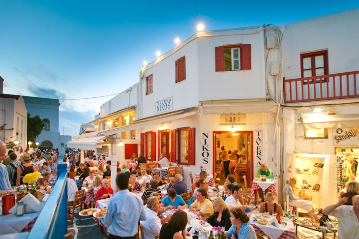 Tourists dining al fresco at Taverna Nikos in Mykonos.