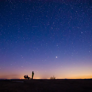Enchanted Rock State Park is one of the Dark Sky area in available in USA. It is an amazing feelings to lie down on top of the hill and to watch at billions of stars. In this picture 3 person is enjoying the beauty of the universe while one can see the bright Jupiter in distance.