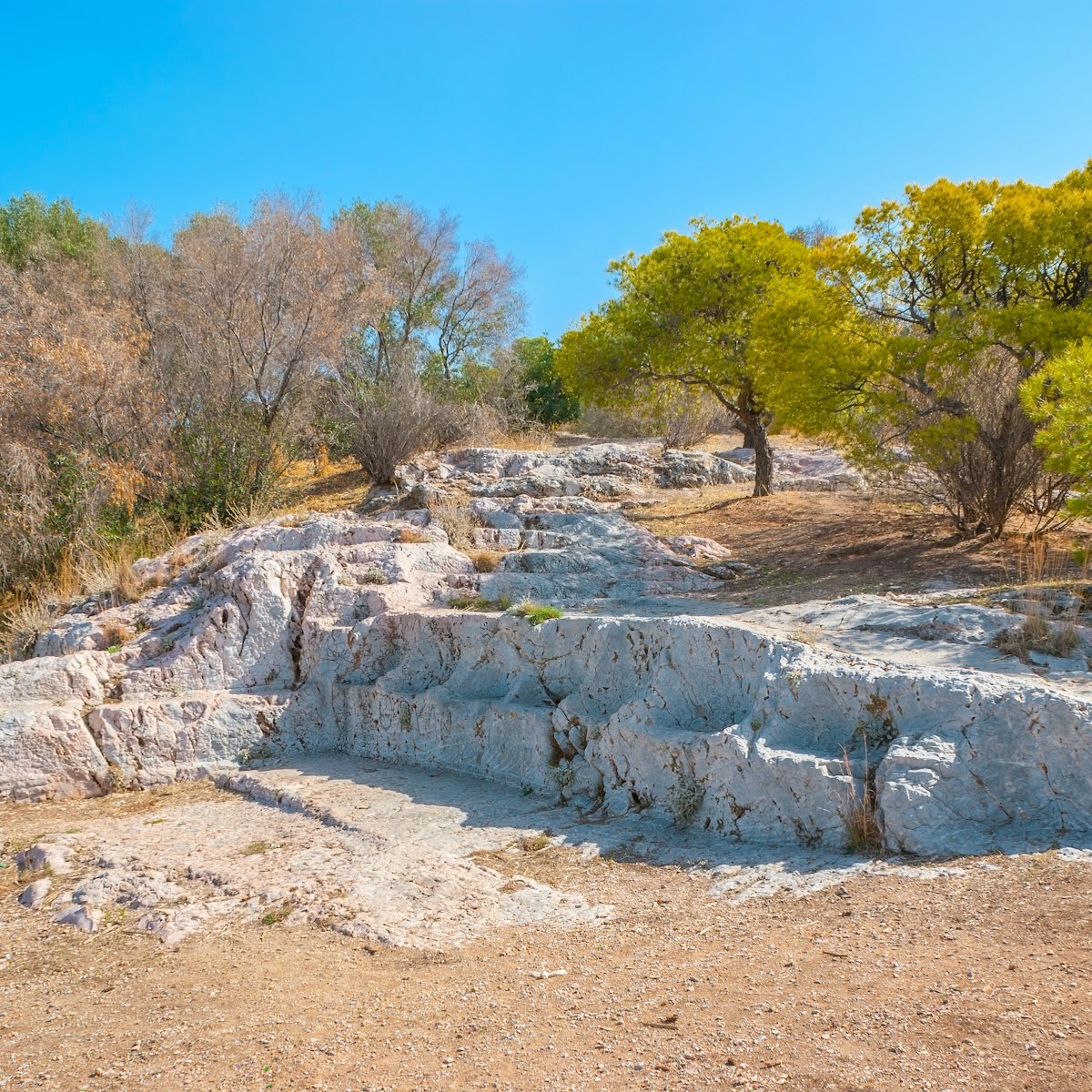 667920832
Ancient; Antique; Archaeology; Architectural Column; Architecture; Athens; Athens - Greece; Attica; Building; Capital Cities; Citadel; City; Cityscape; Column; Court; Democracy; Europe; Famous Place; Seat; Stone; Stone Material; Temple; Temple - Building; Tourism; Travel; Tree; God; Greece; Greek Culture; Hill; History; Horizontal; Marble; Mountain; Museum; No People; Old Ruin; Outdoors; Paganism; Photography; Place; Pnyx; Rock; Ruin;
The seats of Pnyx, a place of gathering for Athenians.