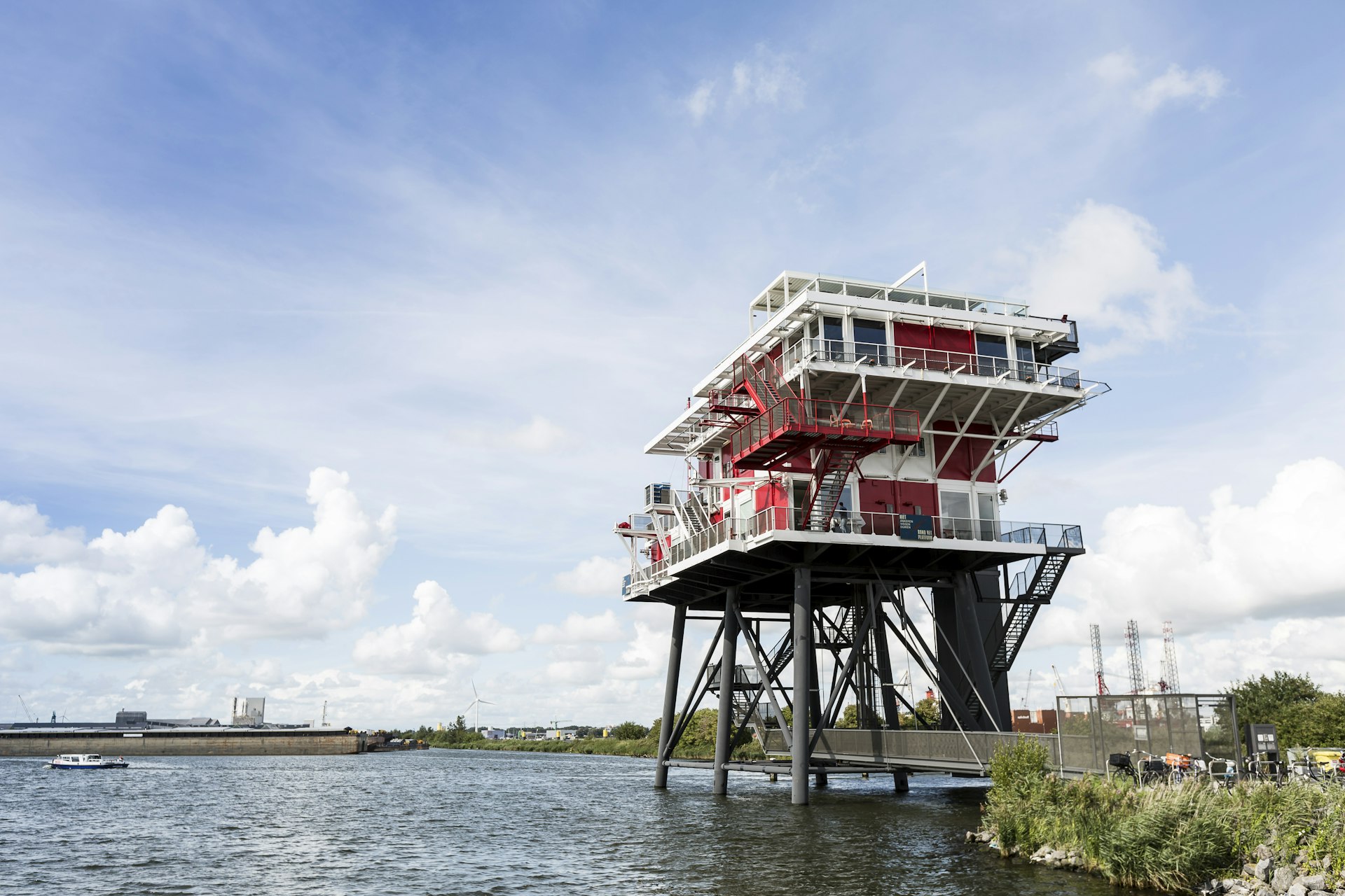 An exterior view of REM Eiland restaurant in Amsterdam towering above the water