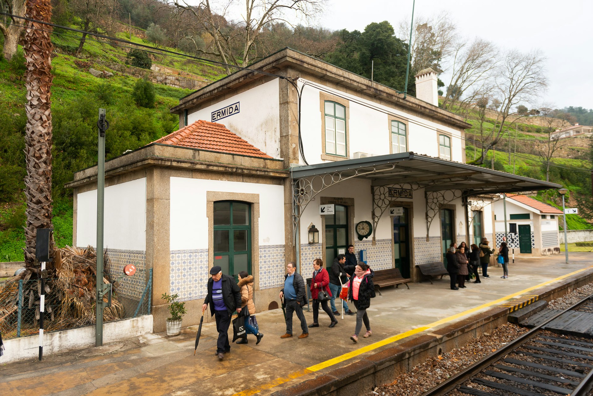 A typical small rural station with passengers moving along the platform