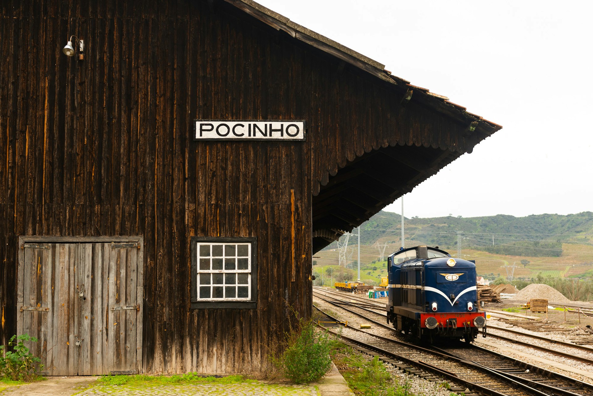 A wooden station building beside a train engine