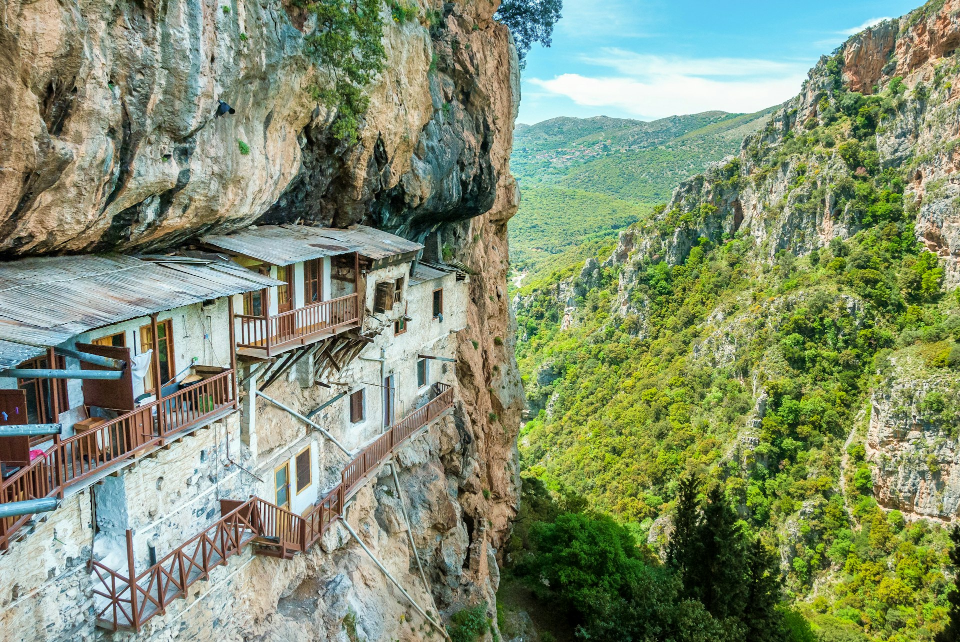 A rocky monastery built into the side of a cliff