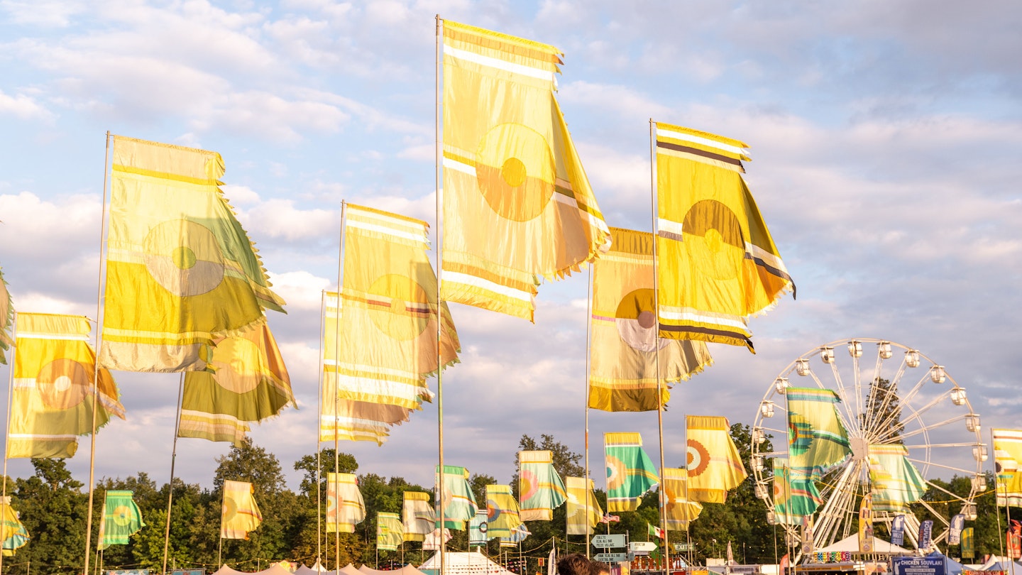 Yellow flags adorn the Womad site as the sun sets on its first day reigning in the 40th anniversary celebration WOMAD England 2022