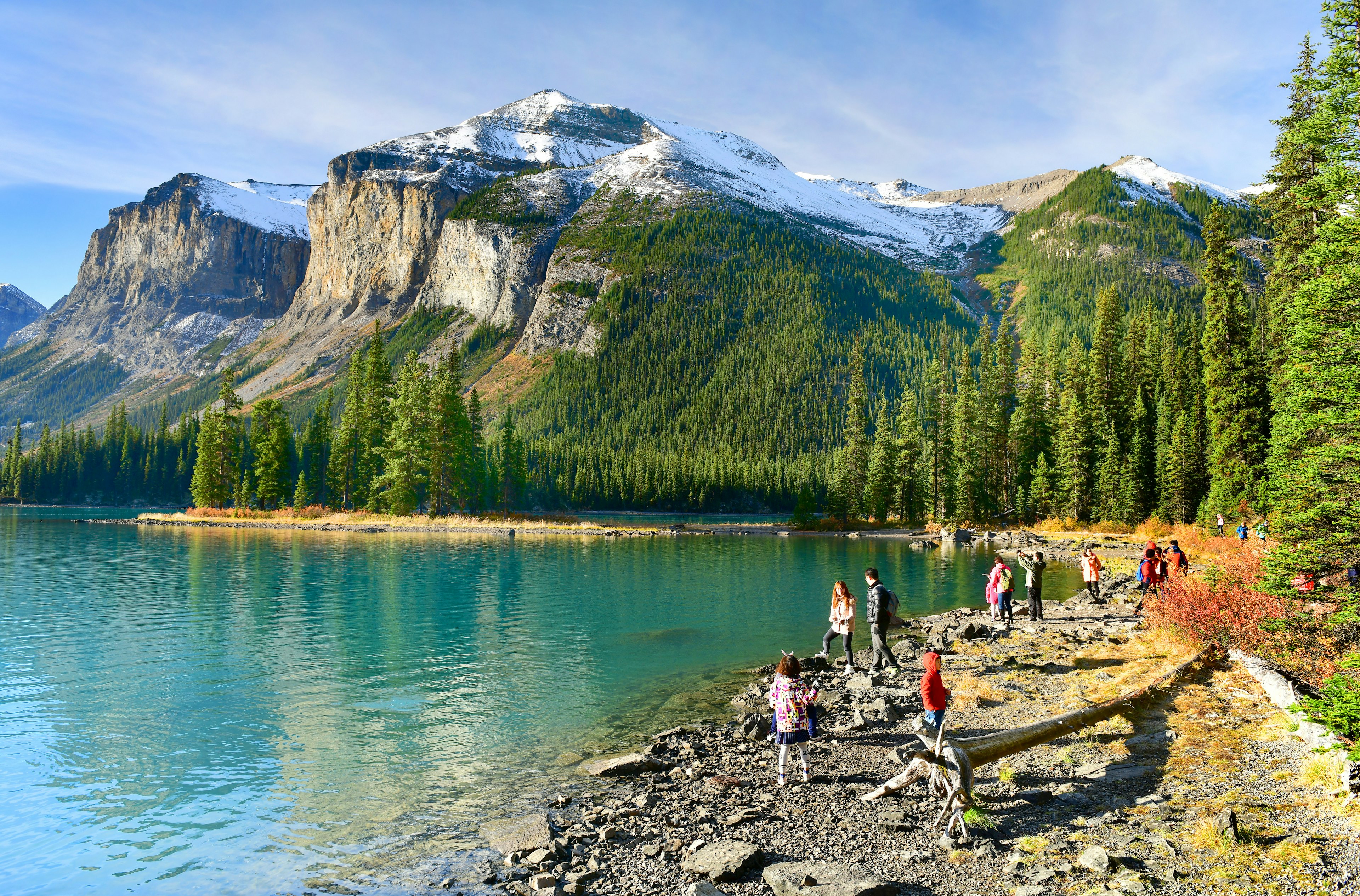 Visitors watching and taking photos of the sunrise at Spirit Island on Maligne Lake.