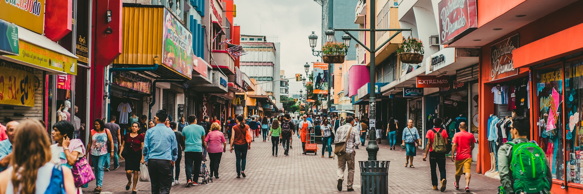 Pedestrians walking in a busy San Jose shopping district.
