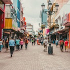 Pedestrians walking in a busy San Jose shopping district.
