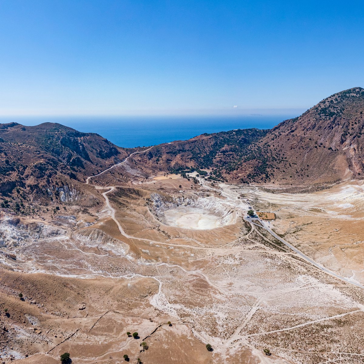 Aerial of the Stefanos volcano crater on Nisyros Island, with the Aegean sea in the background.
1513319564
aegean, aerial, cliff, crater, dodecanese, drone, greece, island, landscape, mountain, nature, nisyros, photo, rock, rocky, sea, stefanos, volcano