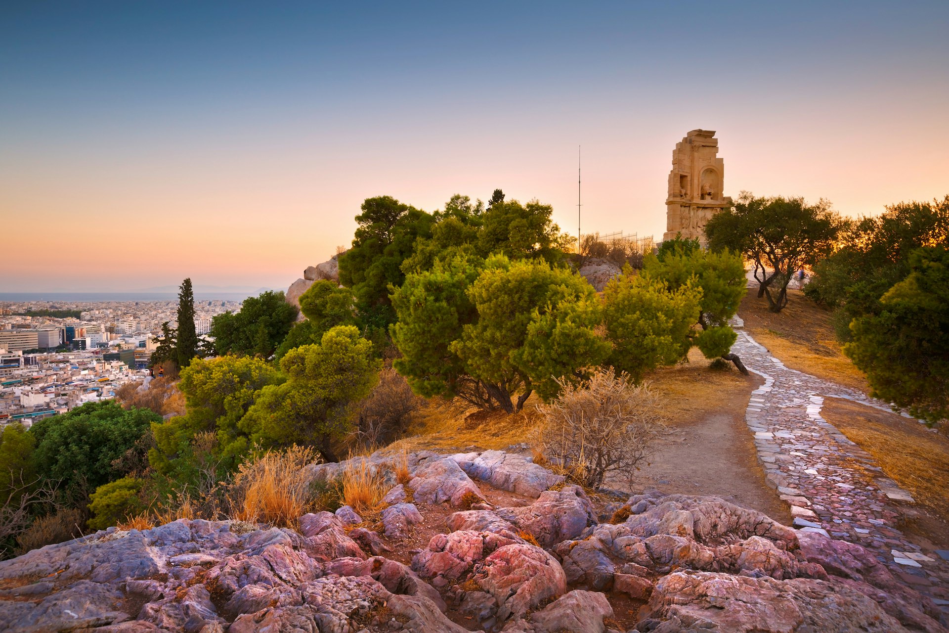 The Philopappos Monument stands among the olive trees of Filopappou Hill with views out across the Athens cityscape