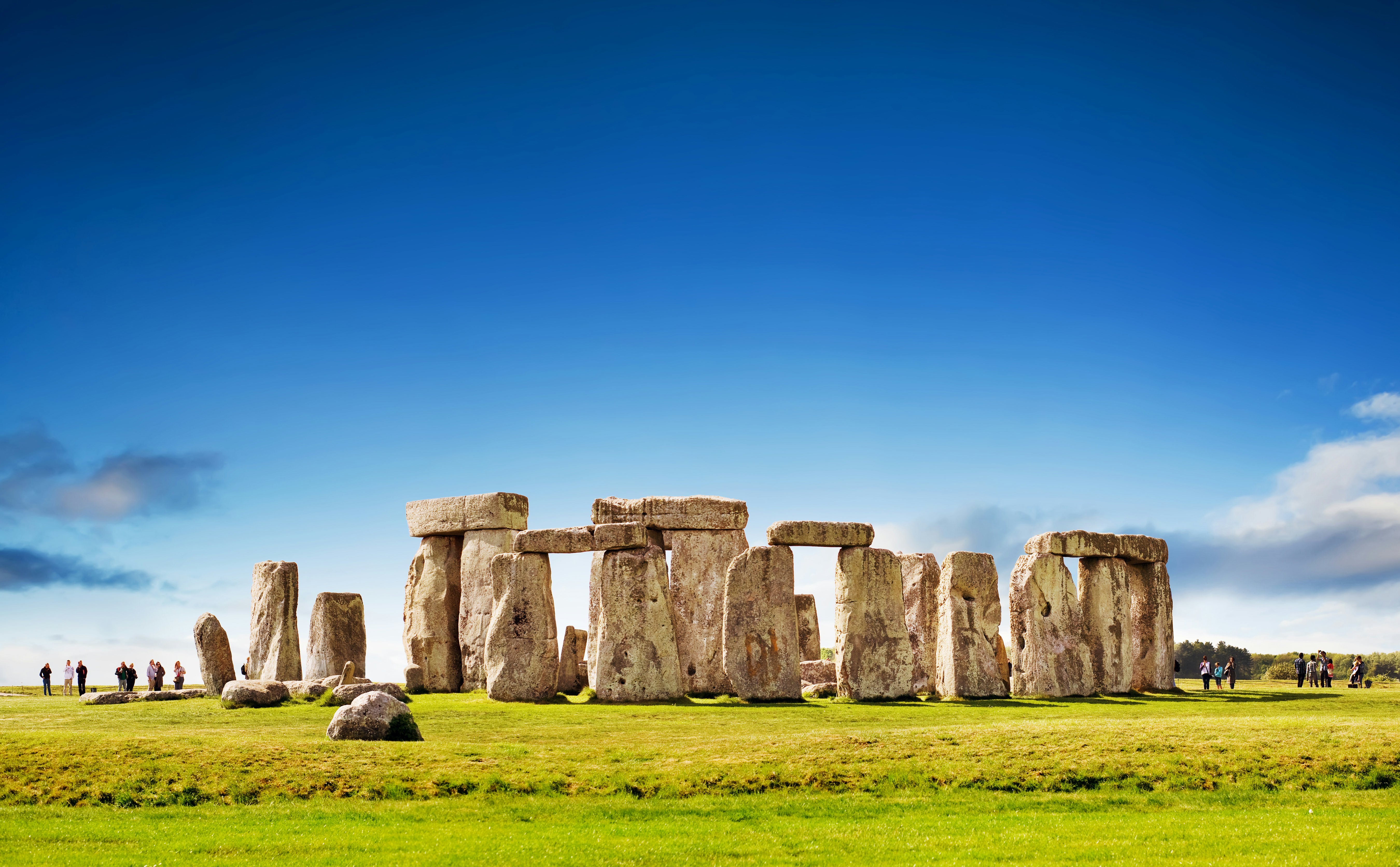 People visit freestanding ancient rocks that form a huge circle