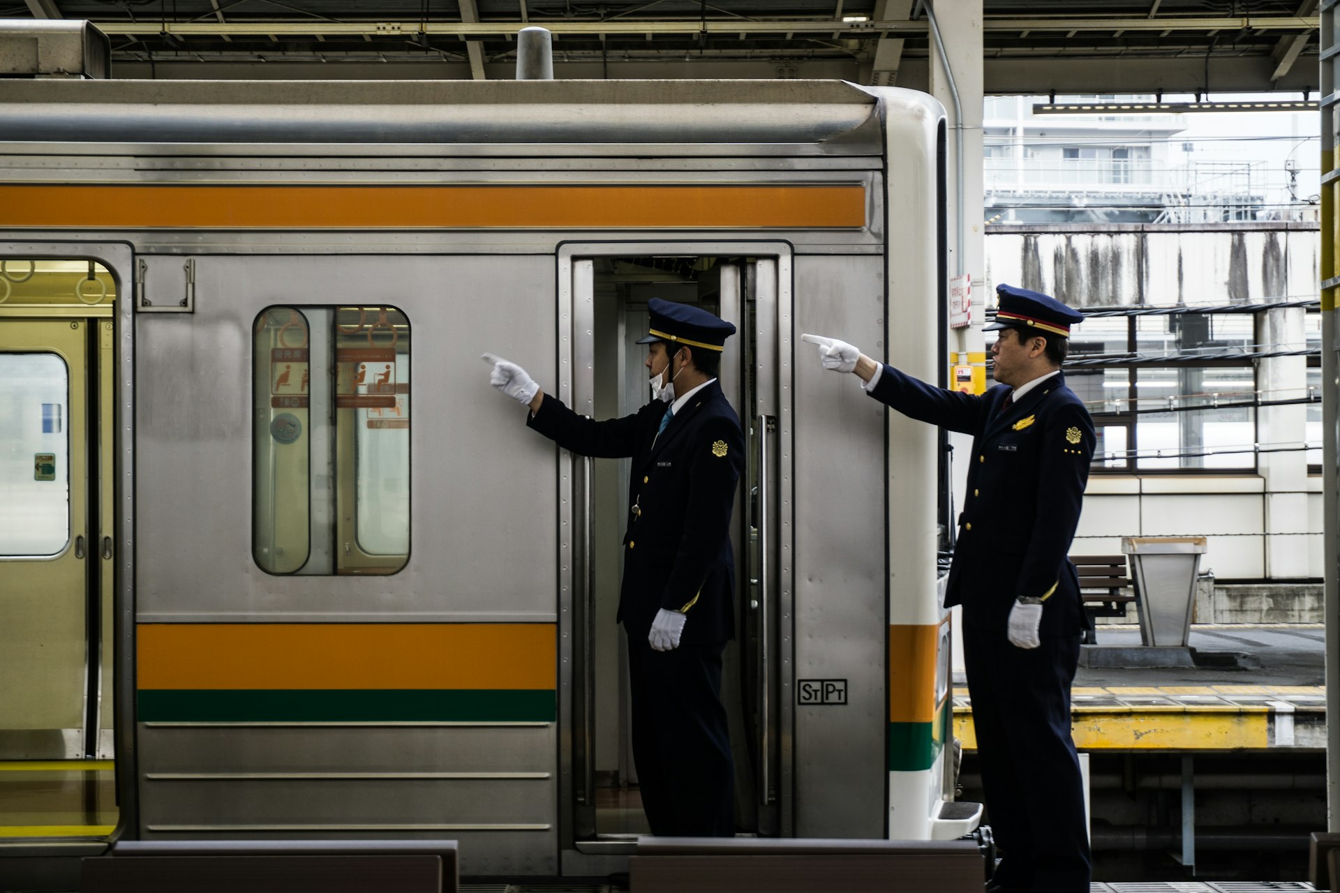 Two train personnel conduct safety checks before departure, Shizuoka, Japan