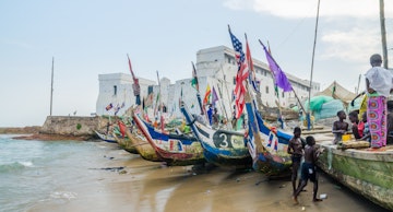Cape Coast, Ghana - February 15, 2014: Colorful moored wooden fishing boats in African harbor town Cape Coast with colonial castle in background; Shutterstock ID 1089742331; your: Barbara Di Castro; gl: 65050; netsuite: digital; full: hub
1089742331