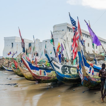 Cape Coast, Ghana - February 15, 2014: Colorful moored wooden fishing boats in African harbor town Cape Coast with colonial castle in background; Shutterstock ID 1089742331; your: Barbara Di Castro; gl: 65050; netsuite: digital; full: hub
1089742331