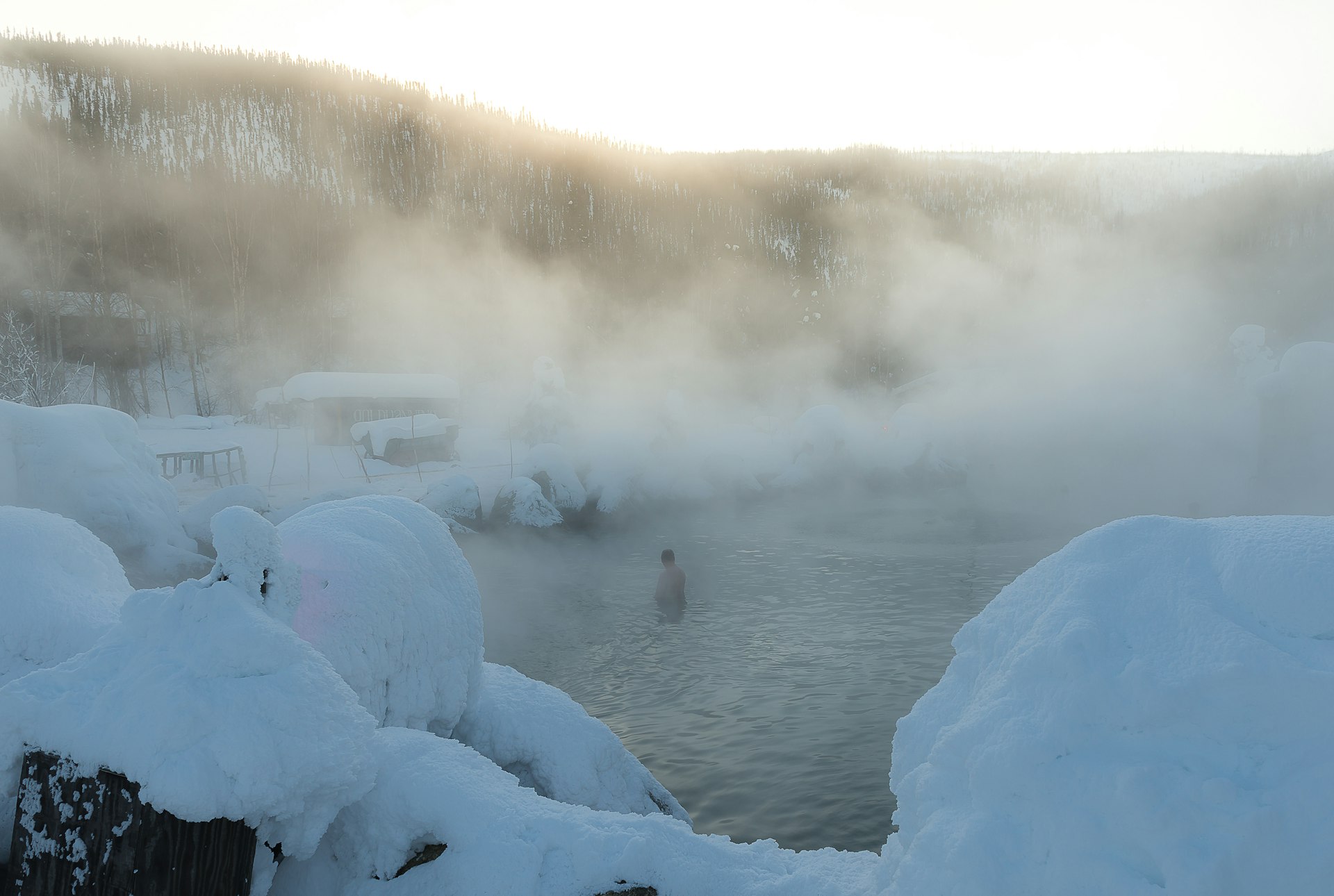Bathers enjoying the Chena Hot Spring on the top of mountain during winter in Alaska