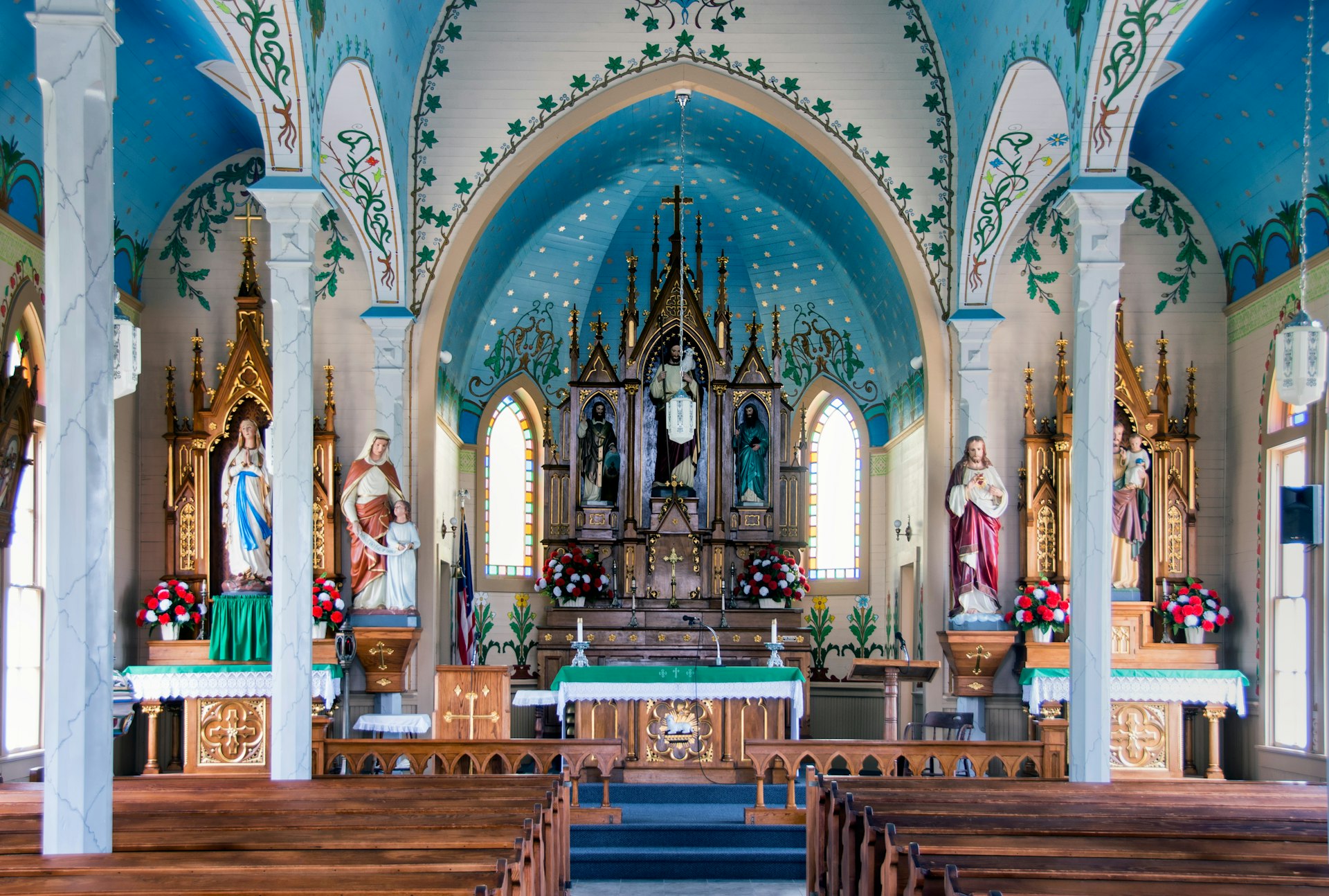 A church altar and surrounds painted in bright colors