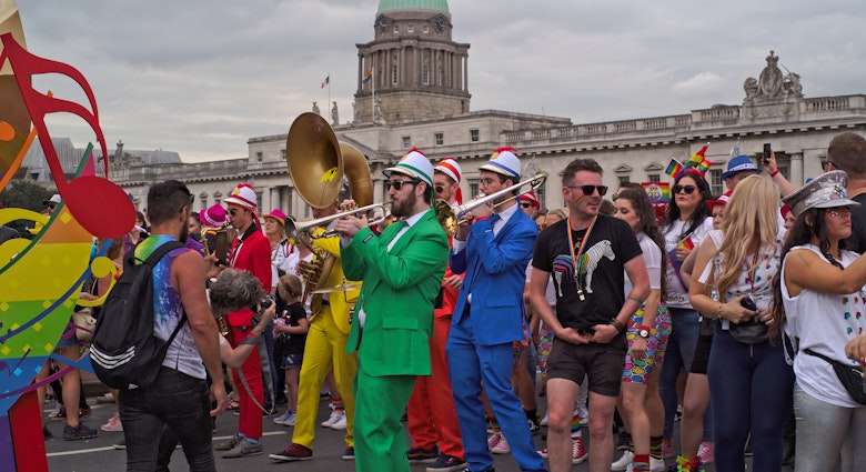 DUBLIN, IRELAND - JUNE 29, 2019: Musicians in colorful costumes play for people in the Dublin LGBTQ Pride Festival in 2019. The Custom House landmark building in the background.; Shutterstock ID 1438317050; your: Brian Healy; gl: 65050; netsuite: Lonely Planet Online Editorial; full: Skip St Patty's for Dublin Pride
1438317050